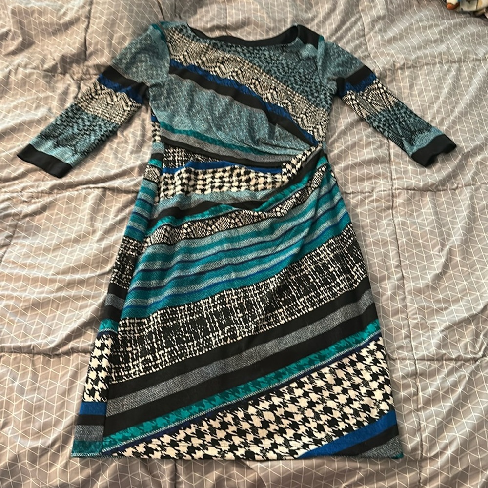 Long sleeve turquoise, green, black, and blue mid length dress .